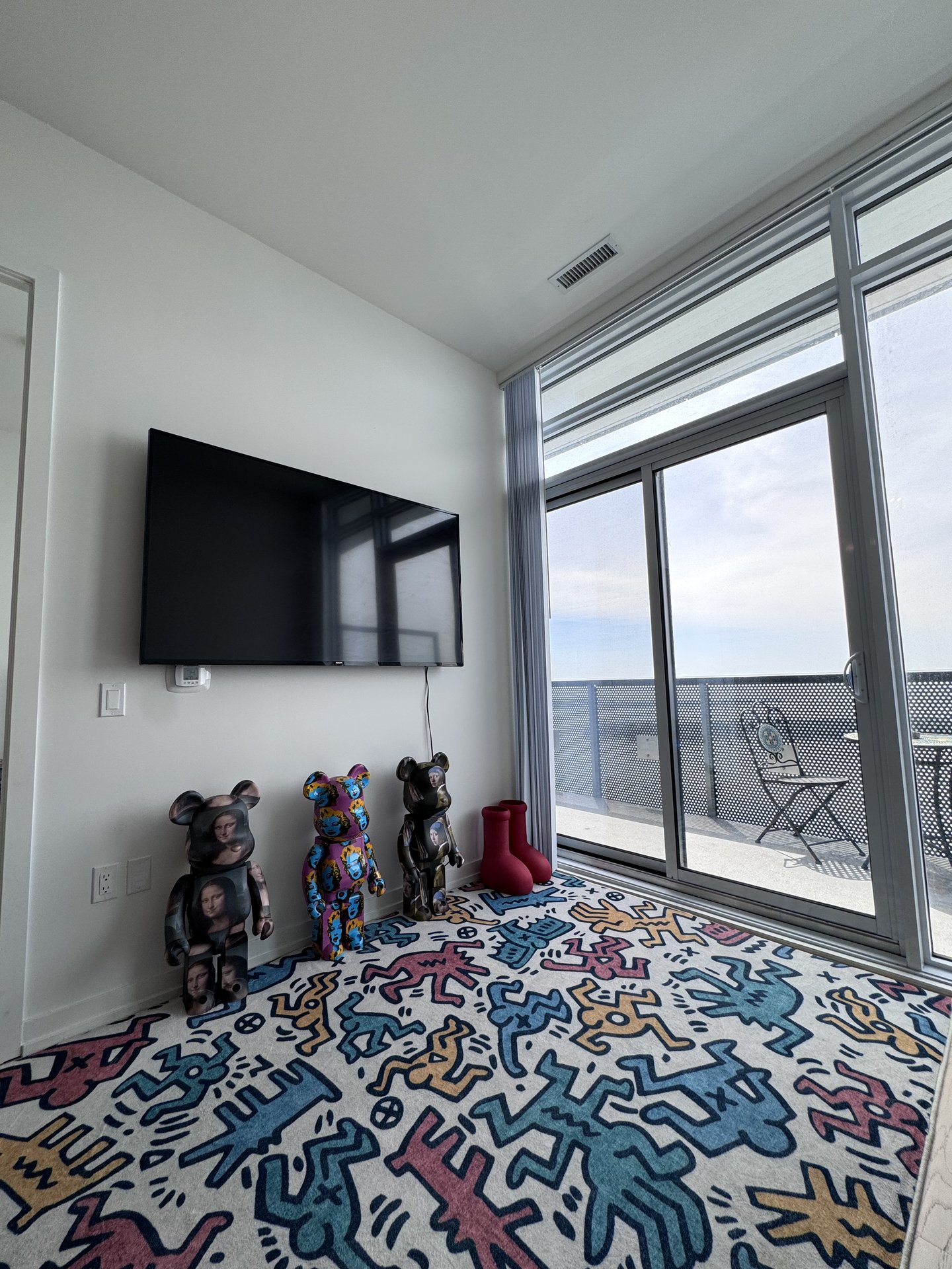 BE@RBRICK collection on Keith Haring rug with Smart TV