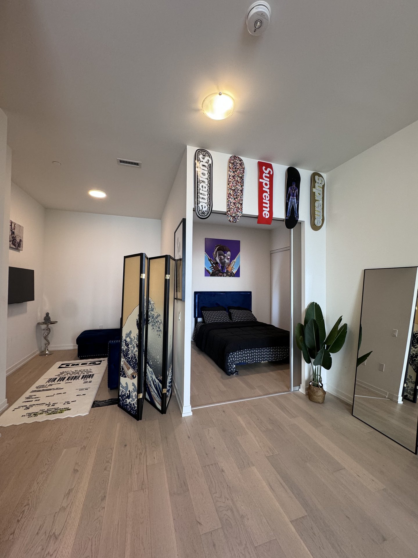 Den nook with Supreme skate decks and Hokusai screen